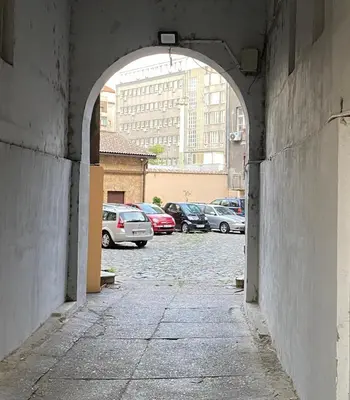 an alley with cars parked in a parking lot at Fellini Apartment in Belgrade