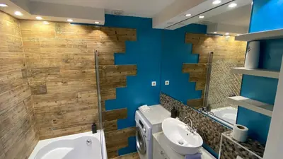 a bathroom with blue walls and a toilet and a sink at Fellini Apartment in Belgrade
