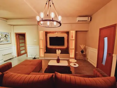 a living room with a couch and a tv at Mystique Spa Apartment in Belgrade