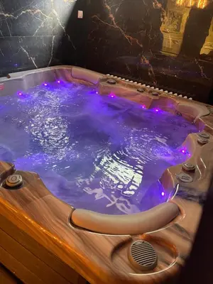 a jacuzzi tub with purple lights on it at Mystique Spa Apartment in Belgrade