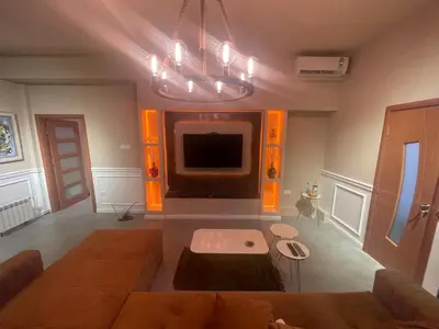 a living room with a couch and a tv at Mystique Spa Apartment in Belgrade