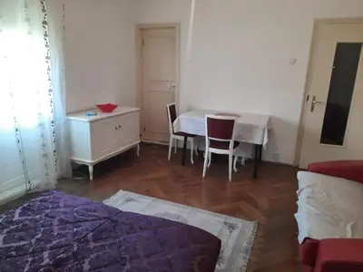a living room with a table and a table and chairs at Nena Apartman in Belgrade