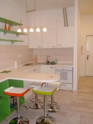 a kitchen with a table and two stools at Porto Studio in Belgrade