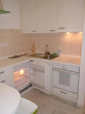 a kitchen with white cabinets and a sink at Porto Studio in Belgrade