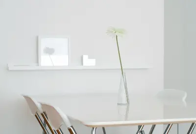a white dining room with a white table and chairs at Miu Arena Apartment in Belgrade