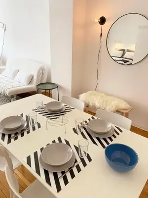 a white dining room with a table and chairs at Miu Arena Apartment in Belgrade