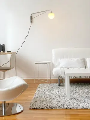 a living room with a white couch and a table at Miu Arena Apartment in Belgrade