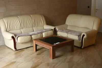 a living room with two couches and a coffee table at Apartman Avala Beograd in Beli Potok