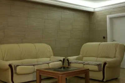 two chairs and a coffee table in a room at Apartman Avala Beograd in Beli Potok