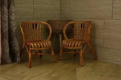 two chairs and a table with a basket on it at Apartman Avala Beograd in Beli Potok