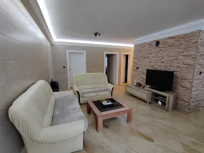 a living room with two couches and a tv at Apartman Avala Beograd in Beli Potok
