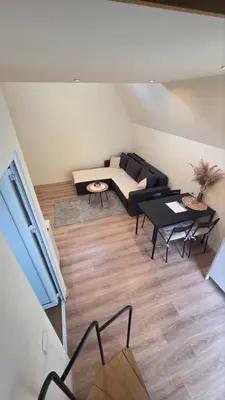 a living room with a couch and a table at Planinske Kuće Grocka in Grocka
