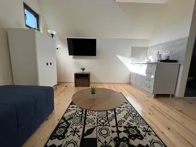 a living room with a blue couch and a table at Planinske Kuće Grocka in Grocka