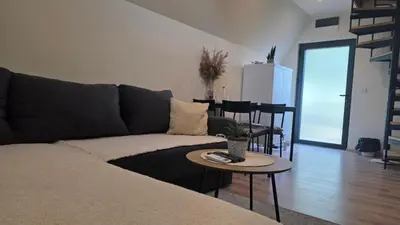 a living room with a couch and a table at Planinske Kuće Grocka in Grocka