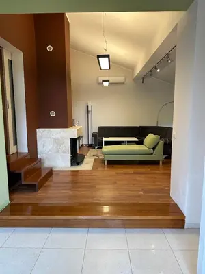 a living room with a couch and a fireplace at Kuca na Dunavu in Belgrade