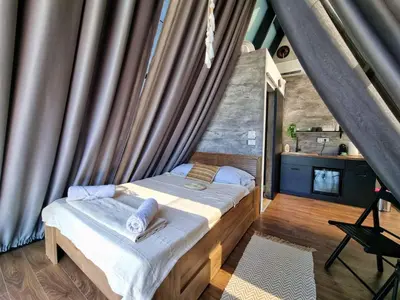 a bedroom with a bed in a room at Glamping A frame lake Heated pool in Barajevo