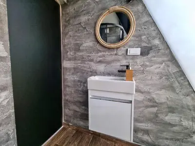 a bathroom with a sink and a mirror at Glamping A frame lake Heated pool in Barajevo