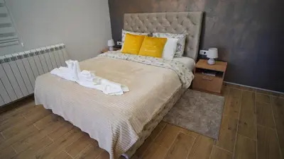 a bedroom with a large bed with towels on it at President 034 Royal Spa in Arandjelovac