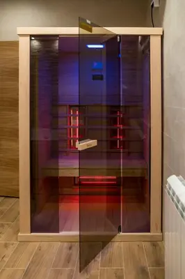 a glass display case with a bench in a room at President 034 Royal Spa in Arandjelovac