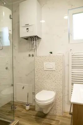 a bathroom with a toilet and a glass shower at President 034 Royal Spa in Arandjelovac