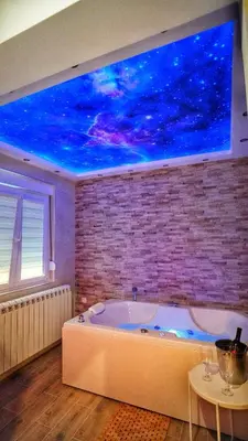 a bath tub in a room with a blue ceiling at President 034 Royal Spa in Arandjelovac