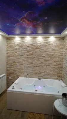 a bath tub in a room with a star ceiling at President 034 Royal Spa in Arandjelovac