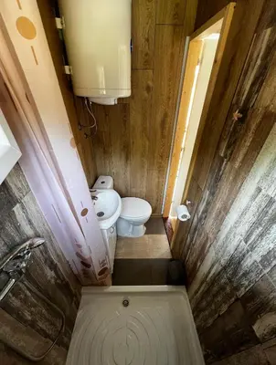 a small bathroom with a toilet and a sink at Splav na reci Savi in Ostružnica