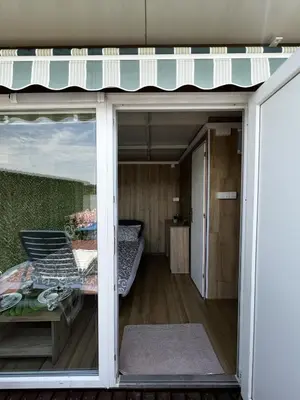 a room with a sliding glass door leading to a bedroom at Splav na reci Savi in Ostružnica
