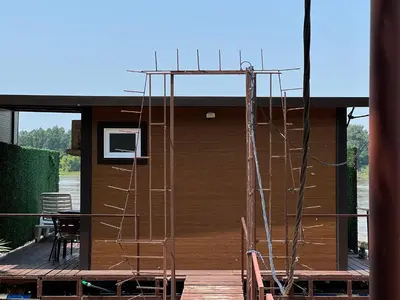 a house being built on a deck with scaffolding at Splav na reci Savi in Ostružnica
