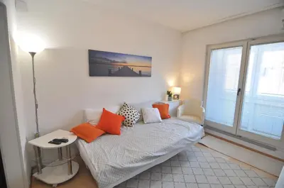 a bedroom with a bed with orange pillows on it at Charming studio near downtown in Belgrade