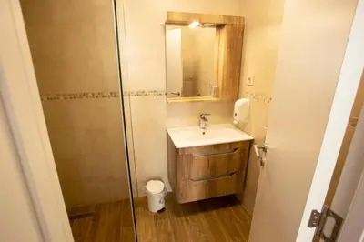 a bathroom with a sink and a shower with a mirror at Soul River e cucina in Pančevo