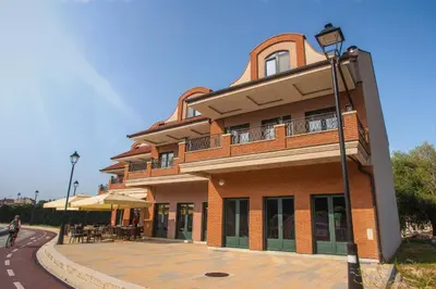 a large brick building with a patio in front of it at Soul River e cucina in Pančevo