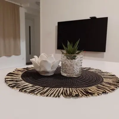 a table with a vase and flowers on a table at Studio Neimar in Vračar (historical)