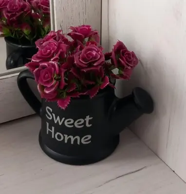 a black vase with pink flowers in it at Studio Neimar in Vračar (historical)