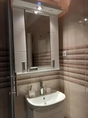 a bathroom with a sink and a mirror at Studio Neimar in Vračar (historical)