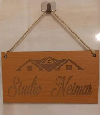 a sign for a house hanging on a wall at Studio Neimar in Vračar (historical)