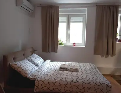 a bedroom with a bed with two towels on it at Studio Neimar in Vračar (historical)