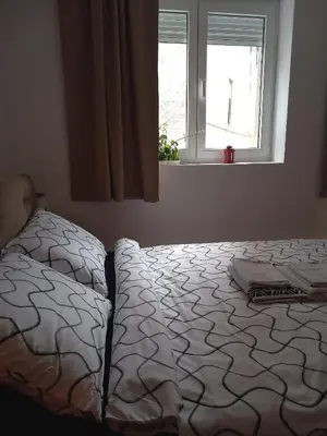 a bedroom with a bed and a window at Studio Neimar in Vračar (historical)