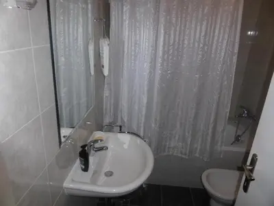 a bathroom with a sink and a shower and a toilet at Apartment Deligradska in Belgrade