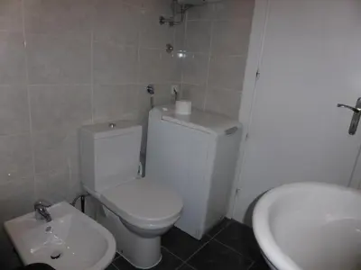 a bathroom with a white toilet and a sink at Apartment Deligradska in Belgrade