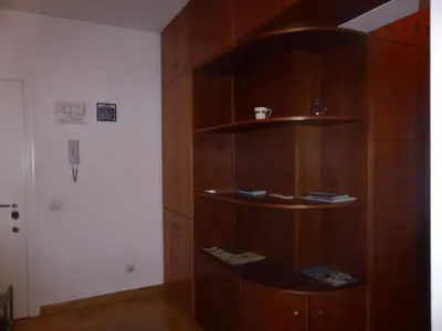 a room with a wooden book shelf with books at Apartment Deligradska in Belgrade