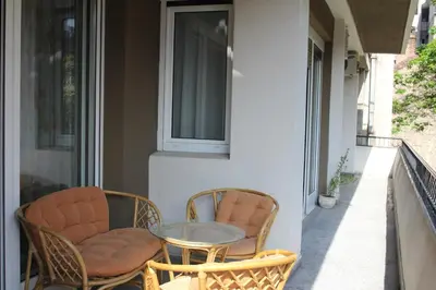 a patio with two chairs and a table on a porch at Apartment Deligradska in Belgrade