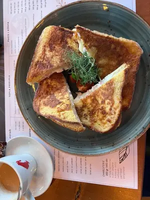 a plate with two slices of toast on a table at Biser apartman in Belgrade