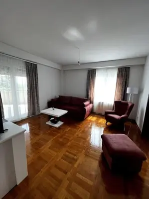 a living room with a couch and a table at Biser apartman in Belgrade
