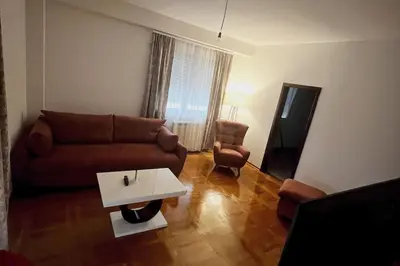 a living room with a couch and a coffee table at Biser apartman in Belgrade
