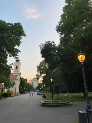 a street light in a park with a clock tower at Jasna in Zemun