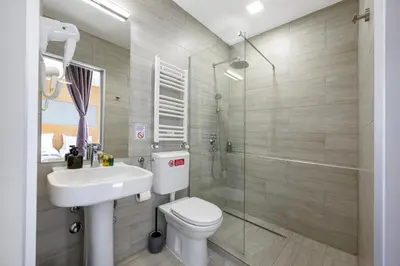 a bathroom with a toilet and a sink and a shower at Prince Rooftop in Belgrade