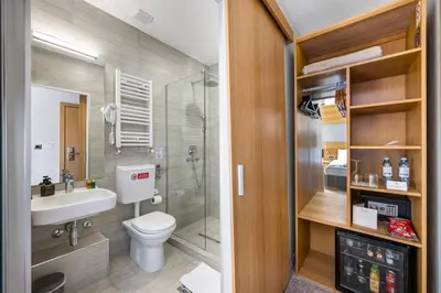a bathroom with a toilet and a sink and a shower at Prince Rooftop in Belgrade