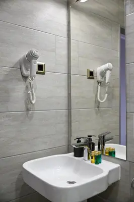 a bathroom with a white sink and a mirror at Prince Rooftop in Belgrade