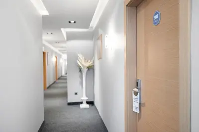 a hallway with a door and a vase of flowers at Prince Rooftop in Belgrade